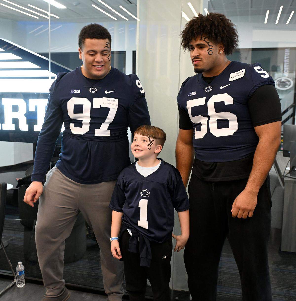 Christian Holder, 8, had his face painted with Keanu Williams and Alijah Carnell during the Thon Explorers event at the Lasch Building on Saturday, Feb. 21, 2026.  