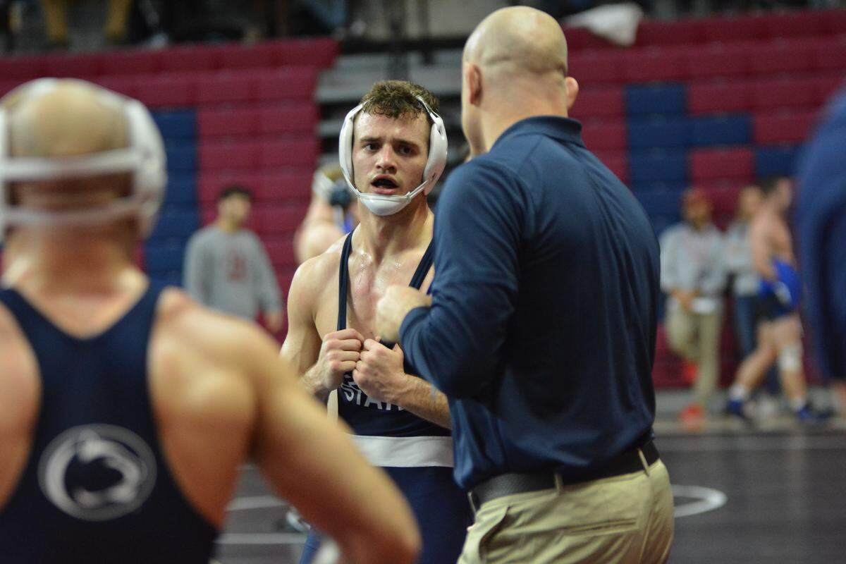 Penn State wrestling coach Cael Sanderson, middle, speaks to Brady Berge during a challenge in his match with teammate Jarod Verkleeren during the Keystone Classic on Sunday. Berge beat Verkleeren 3-2 in their 149-pound semifinal match.