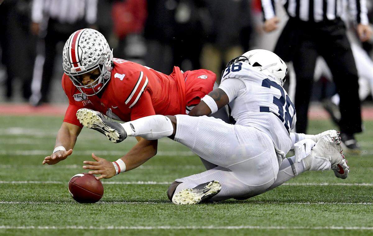 Penn State safety Lamont Wade forces Ohio State quarterback Justin Fields to drop the ball during the game on Saturday, Nov. 23, 2019.