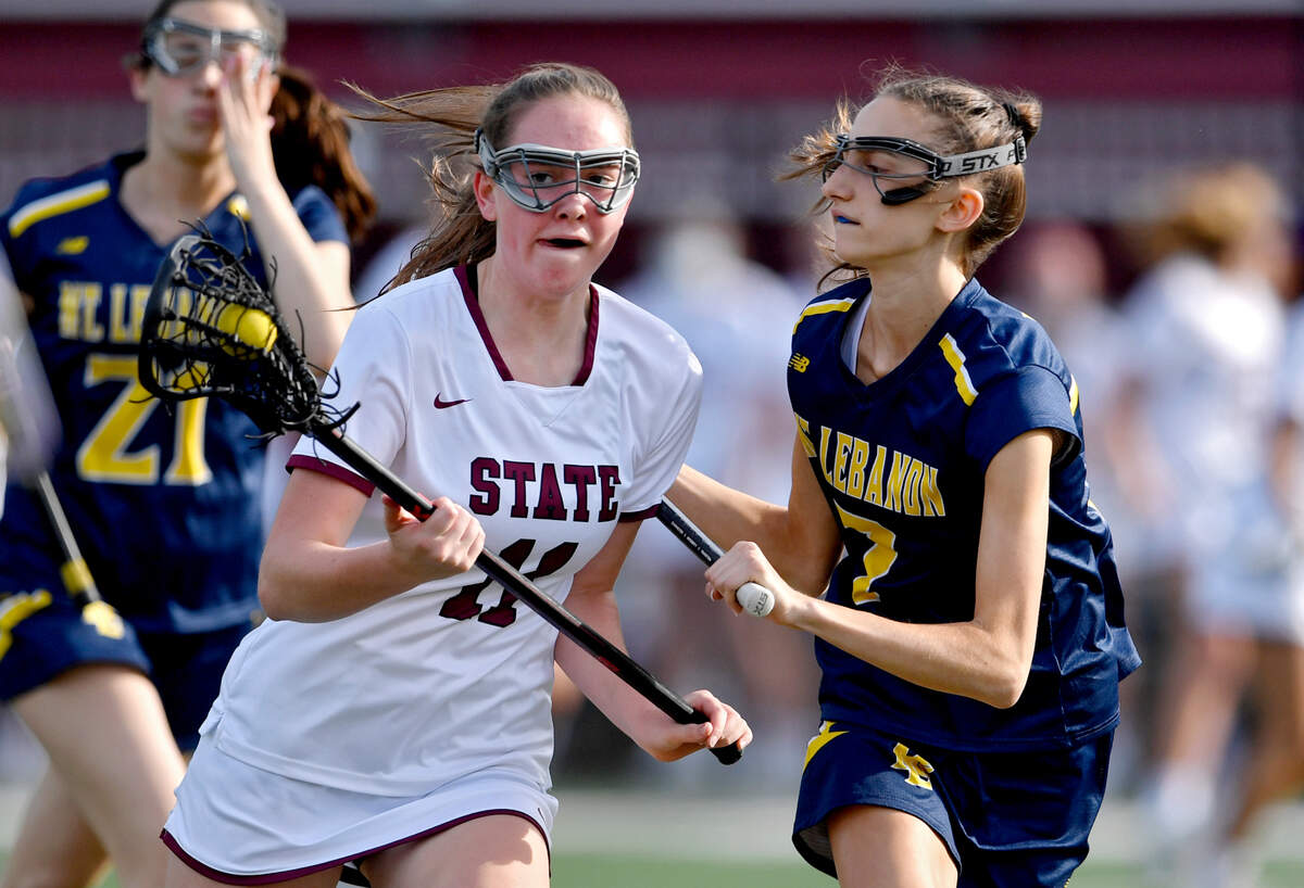State College’s Kaylee Schaefer-Hood cuts down the field with the ball around Mt Lebanon defenders in the game on Tuesday, June 1, 2021.