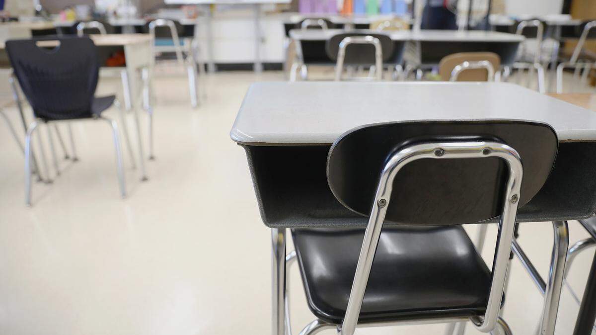 Desks and chairs sit empty in a classroom at Loring Flemming Elementary School in Blackwood, N.J., on Wednesday, Oct. 14, 2020.