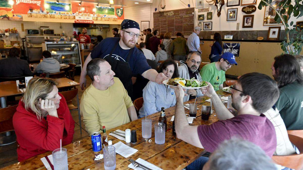 Greg Allen serves food to diners Saturday at Herwig's Austrian Bistro. The downtown State College restaurant is slated to close this week.