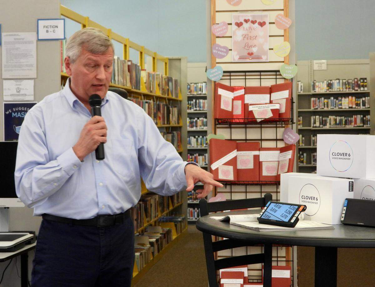 Brandon DeArment, technology specialist at North Central Sight Services, gives a demostration of assistive technology donated to the Centre County Library. The devices will assist people with low vision to better access library materials.