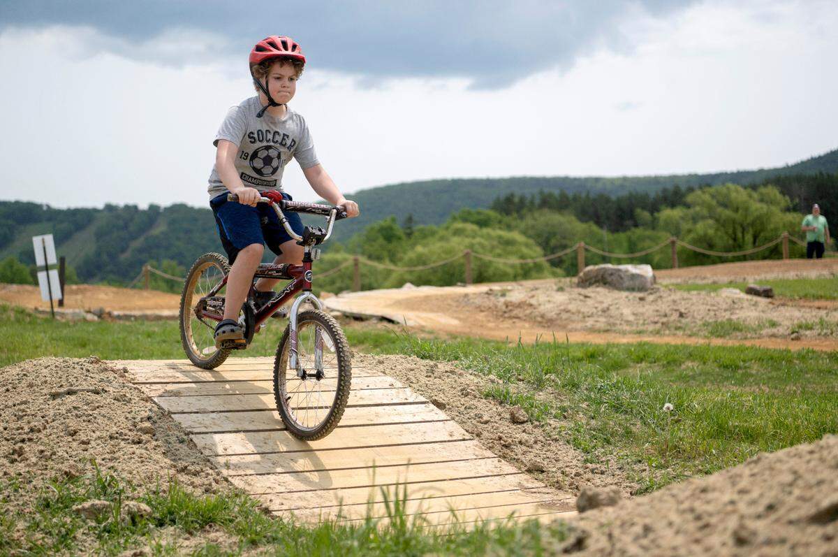 Mack Marshall, 7, focuses as he bikes at the Harvest Fields Community Trails Bike Park on Monday, May 22, 2023. Marshall, who is homeschooled, was excited to try out the park for the second day in a row.