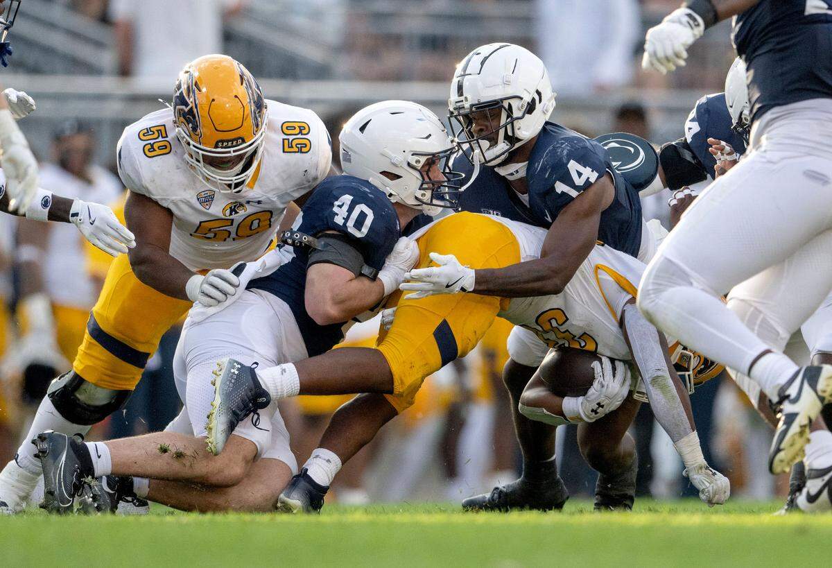 Penn State linebacker Anthony Speca and safety Tyrece Mills stop Kent State’s ball carrier during the game on Sept. 21 at Beaver Stadium.