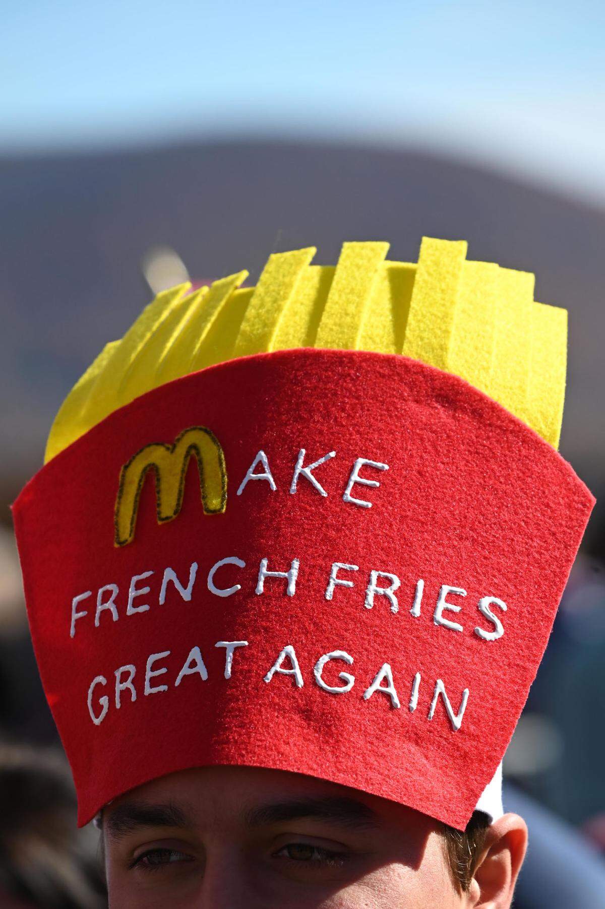 Brandon Godshall wears a hat reading “Make French Fries Great Again” as he waits in line outside the Bryce Jordan Center for a Trump rally on Saturday, Oct. 26, 2024.