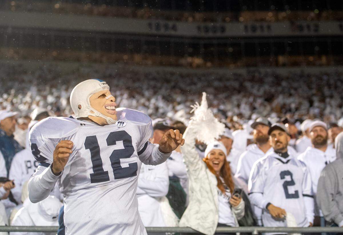 Penn State fans sing and dance during the White Out game against Iowa on Saturday, Sept. 23, 2023.
