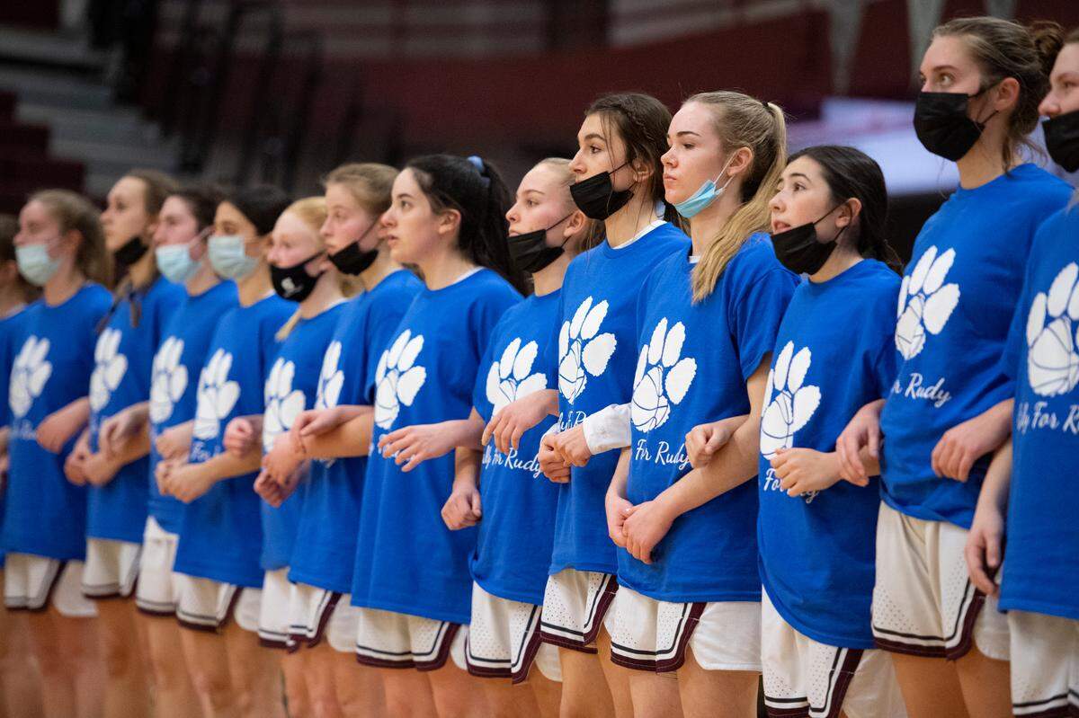 State College girls basketball team members stand together during Tuesday’s “Blue Out” game for longtime educator and coach Rudy Burruss.