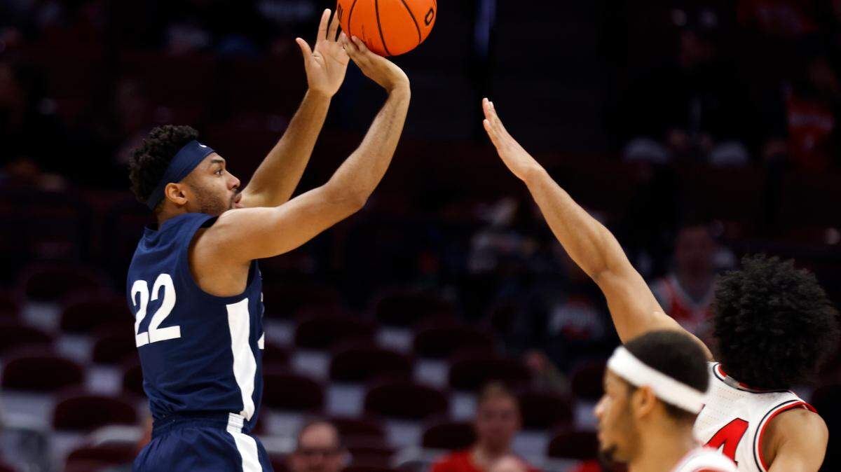 Penn State guard Jalen Pickett shoots next to Ohio State forward Justice Sueing, right rear, and guard Roddy Gayle during the second half of an NCAA college basketball game in Columbus, Ohio, Thursday, Feb. 23, 2023.