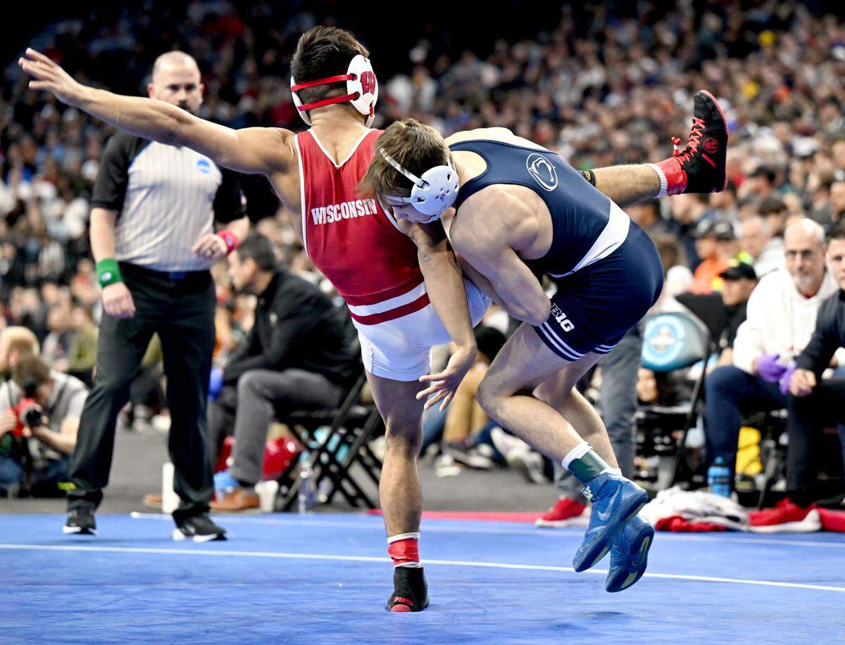Penn State’s Luke Lilledahl trips up Wisconsin’s Nicolar Rivera in a 125-pound bout at the 2025 NCAA Wrestling Championships in Philadelphia on Friday, March 21, 2025.