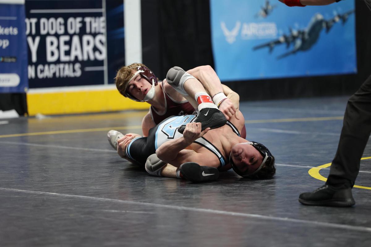 State College’s Hayden Cunningham scrambles with Seneca Valley’s Tyler Chappell in their 127-pound quarterfinals match of the PIAA Class 3A Championships on Friday, March 10, 2023 at the Giant Center in Hershey. Cunningham beat Chappell, 9-4.