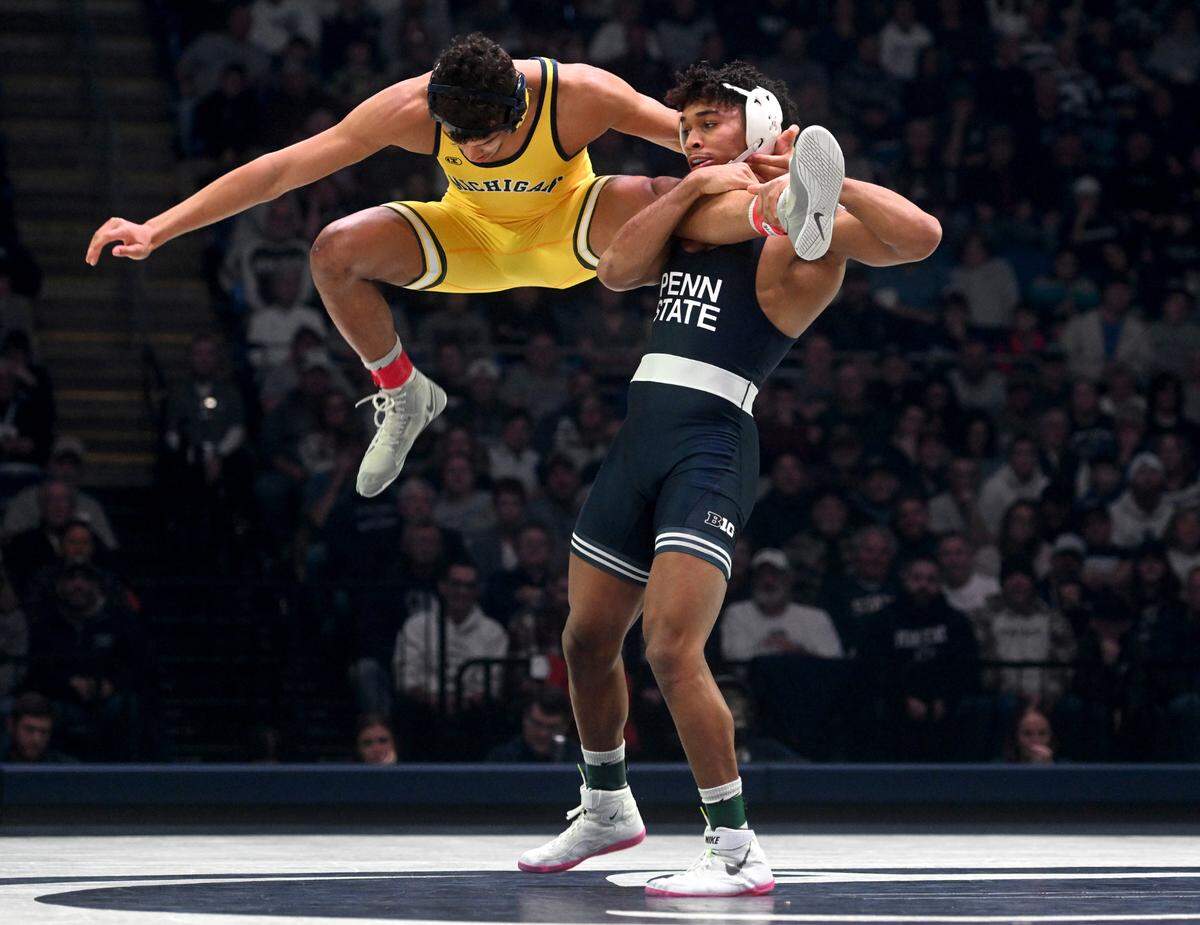 Michigan’s Max Maylor tries to jump away from Penn State’s Carter Starocci during the 174 lb bout of the match on Friday, Jan. 20, 2023 at the Bryce Jordan Center.
