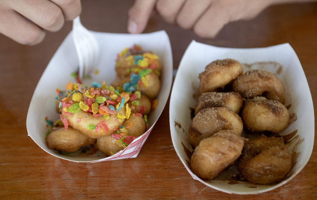 Centre Daily Times reporter Jacob Michael enjoys Fruity Pebbles and cin-bun mini doughnuts from Snowcap Sweets: By Mountaintop Concessions.