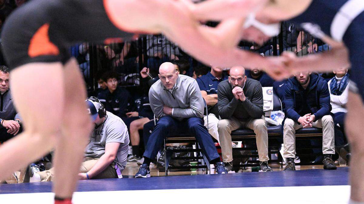Penn State head coach Cael Sanderson (left) and assistant coach Casey Cunningham look on during the 197-pound match between Max Dean and Tanner Harvey on Sunday, Dec. 11, 2022 at Rec Hall in State College. Penn State defeated Oregon State, 31-3.