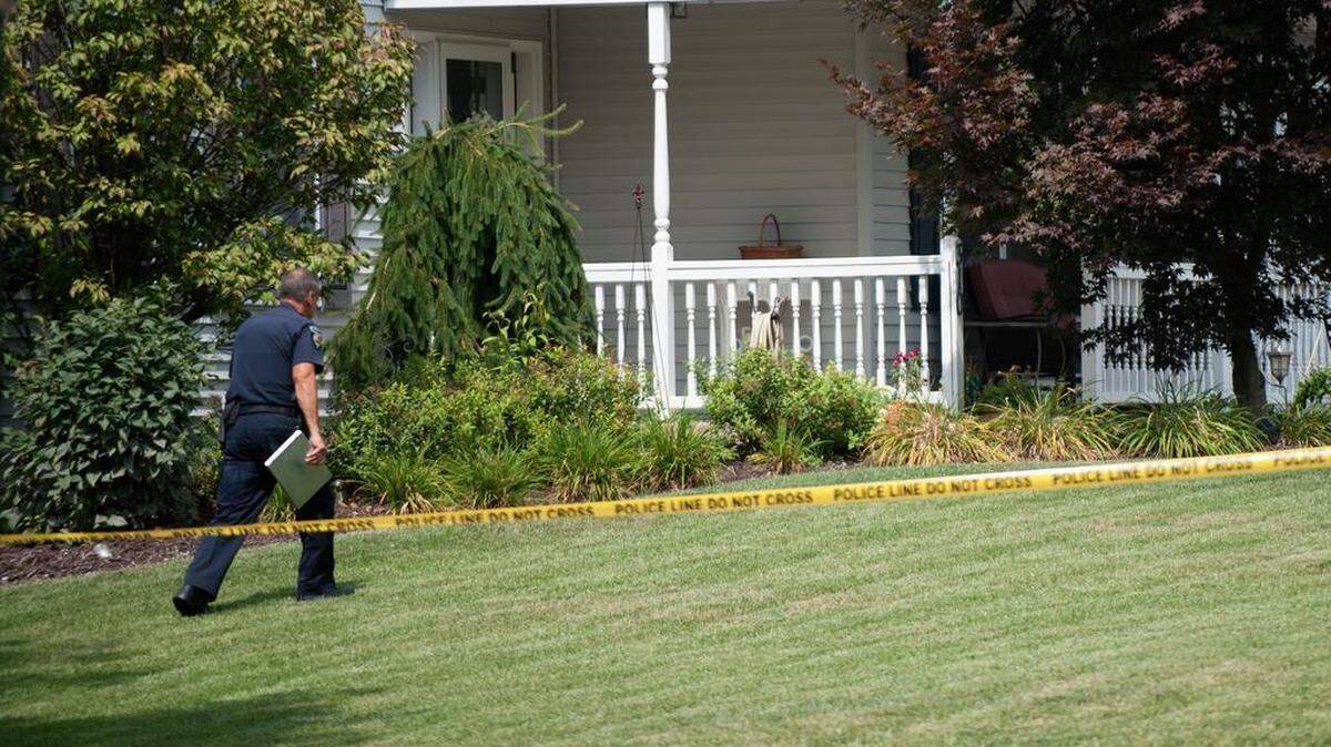 A State College police officer walks to the scene of a shooting on Gregor Way in College Township on Sunday, August 30, 2015.
