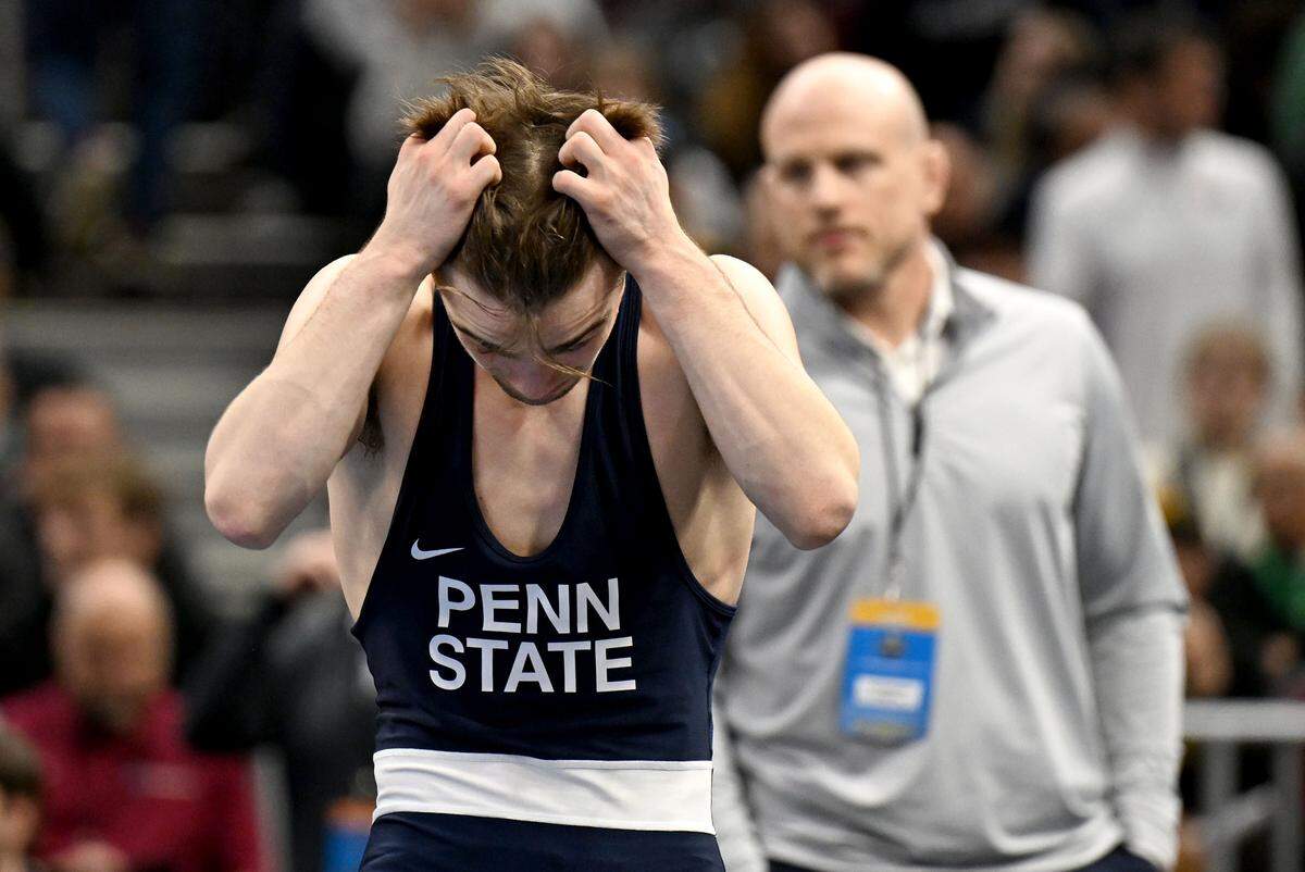 Penn State's Marcus Blaze walks in frustration as the all is reviewed in his match with Ohio State’s Ben Davino in a 133-pound semifinal bout of the NCAA wrestling championships on Friday, March 20, 2026.  