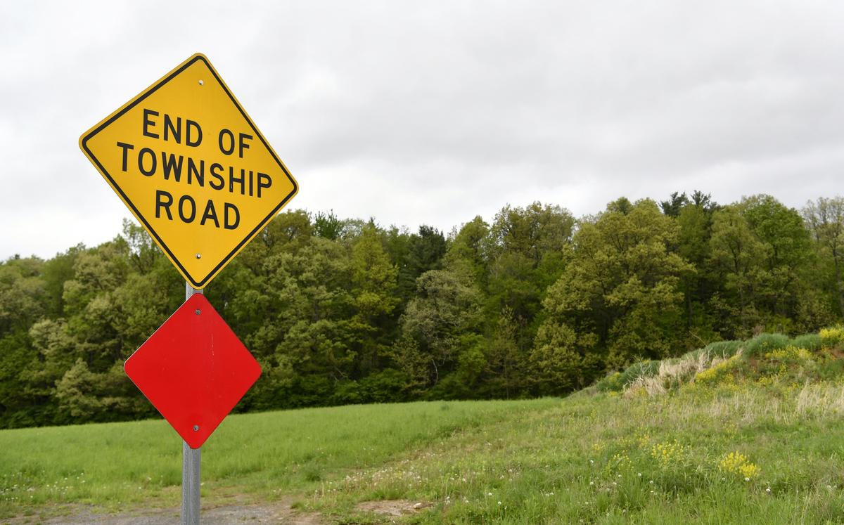 A sign that ends the current portion of Pine Hall Road off of the traffic circle on Old Gatesburg Road. The area and some of the woods is set to be developed into the Pine Hall TTD.