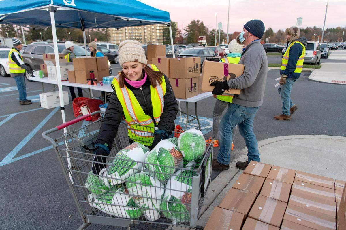 Tara Davis helps distribute turkeys and sides for a Thanksgiving meal to Centre County residents through the Central Pennsylvania Food Bank on Nov. 16, 2021.