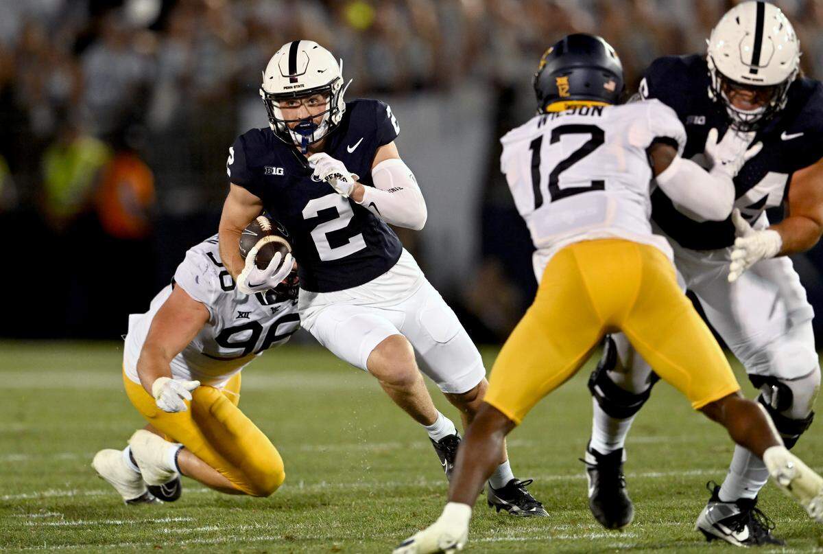 Penn State wide receiver Liam Clifford cuts down the field with the bal from West Virginia defenders during the game on Saturday, Sept. 2, 2023.