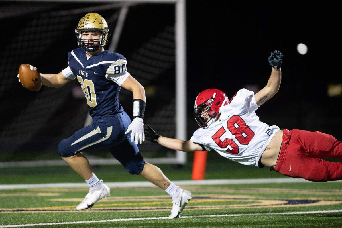 Bald Eagle Area’s Kyler Cunningham evades a tackle from Central Cambria’s Trevor Novotny and scores a touchdown during Bald Eagle Area High School’s game against Central Cambria High School on Friday, Nov. 6, 2020 in Wingate, PA.