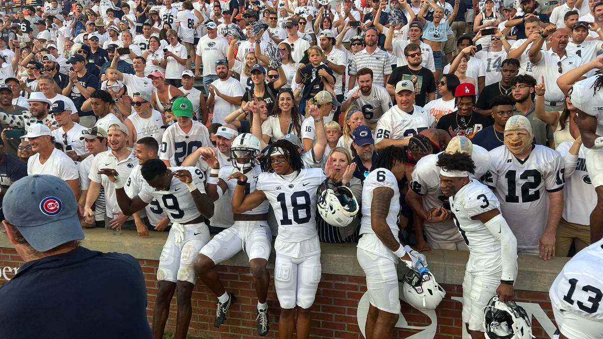 Penn State football players celebrate with fans after defeating the Auburn Tigers at Jordan-Hare Stadium in 2022.