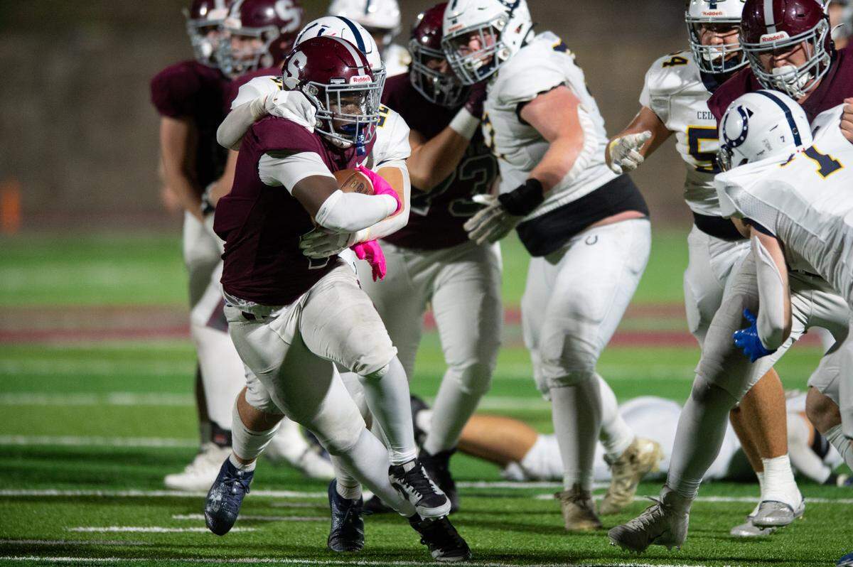 State High running back Lamar Wilson breaks a tackle during the football game at Memorial Field on Friday, Oct. 4, 2024.