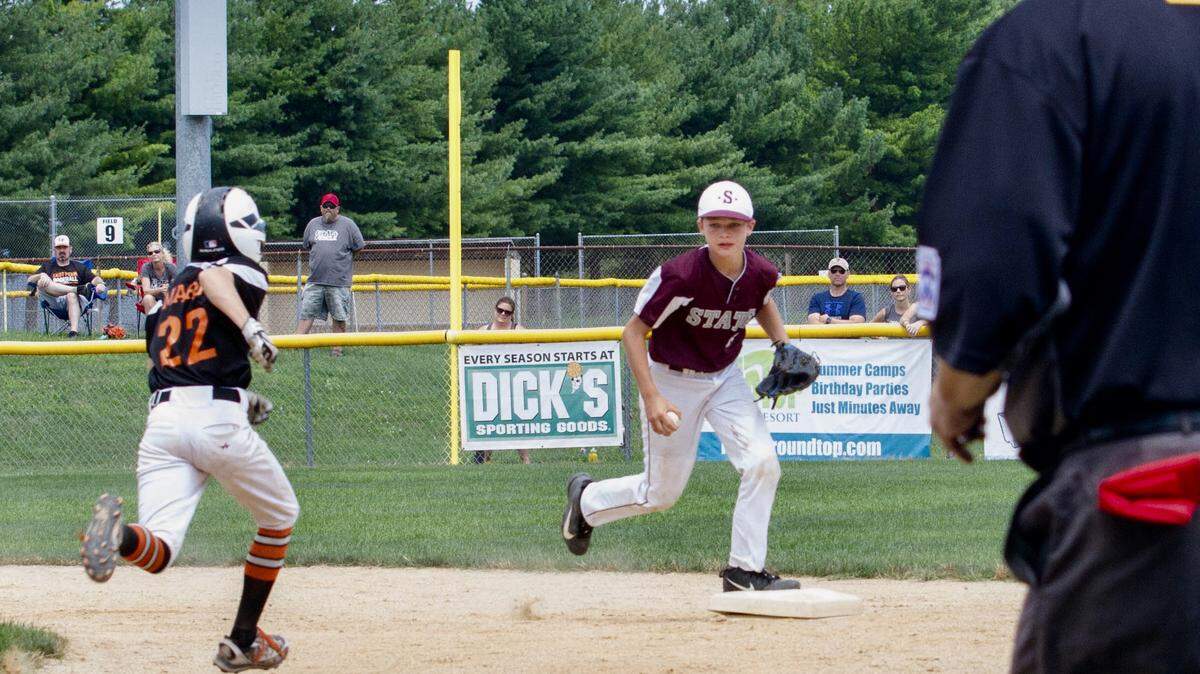 State College Little League’s Chris Warner tags the base for an out Sunday against East Pennsboro in the Section 4 Majors tournament in Mechanicsburg. East Pennsboro won 3-2 in extra innings.