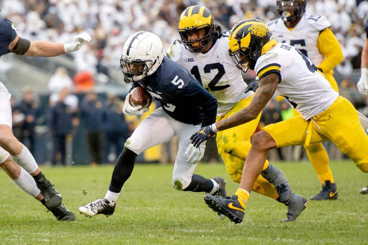 Michigan defenders reach for Penn State wide receiver Jahan Dotson during a game on Saturday, Nov. 13, 2021.