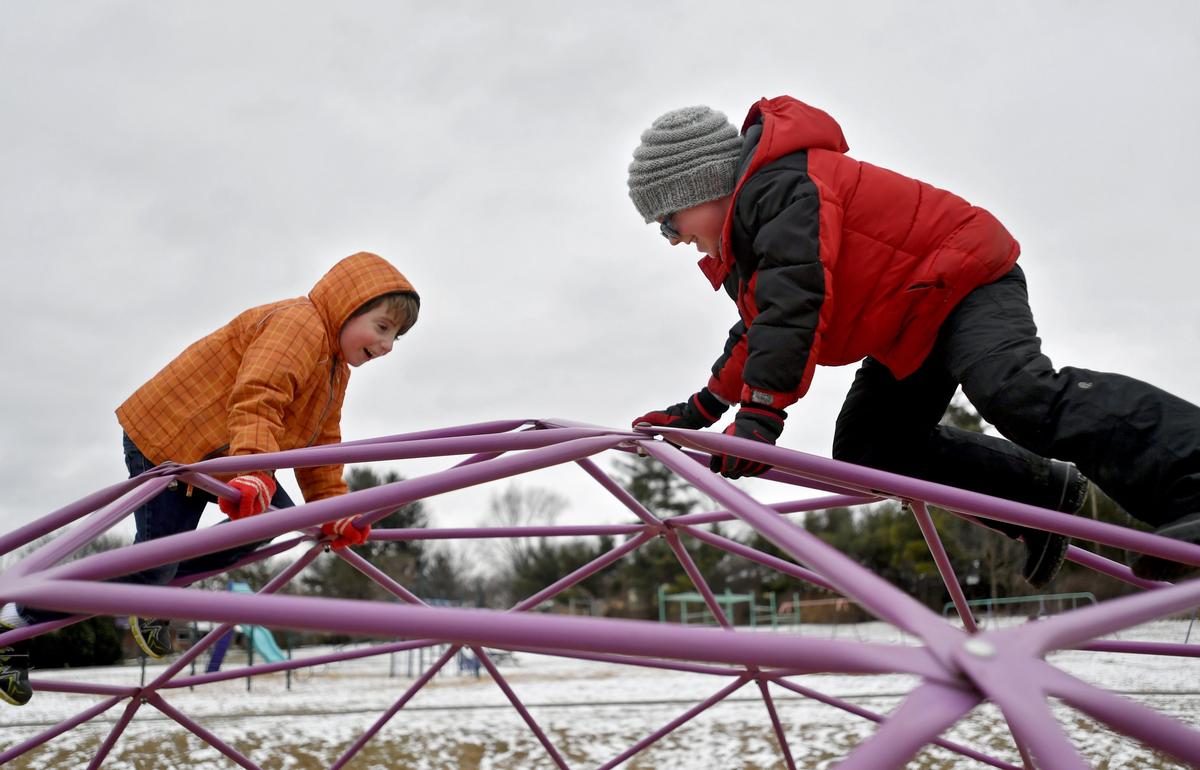 Second graders Zane Guggenburger and Luke Revis climb on the jungle gym on the playground at Easterly Parkway Elementary on Jan. 16.
