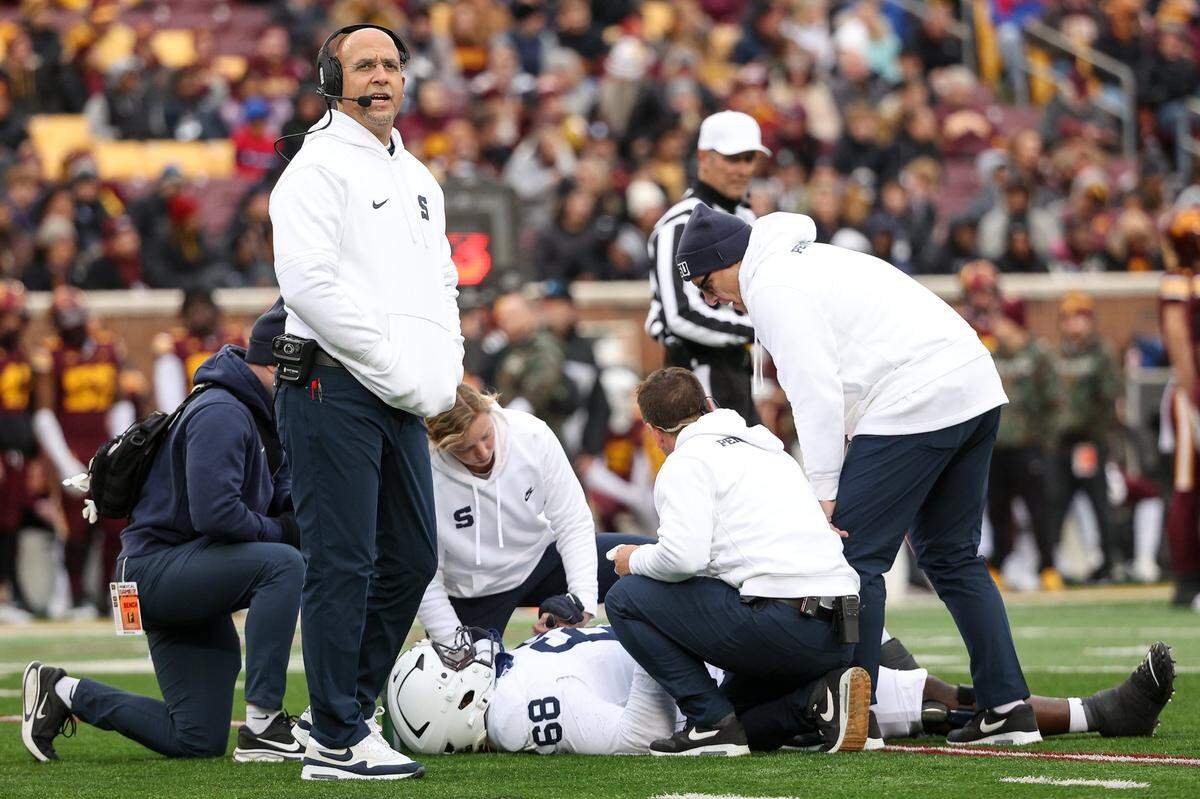 Nov 23, 2024; Minneapolis, Minnesota, USA; Penn State Nittany Lions head coach James Franklin looks on as offensive lineman Anthony Donkoh (68) is looked at by training staff during the first quarter against the Minnesota Golden Gophers at Huntington Bank Stadium. Mandatory Credit: Matt Krohn-Imagn Images