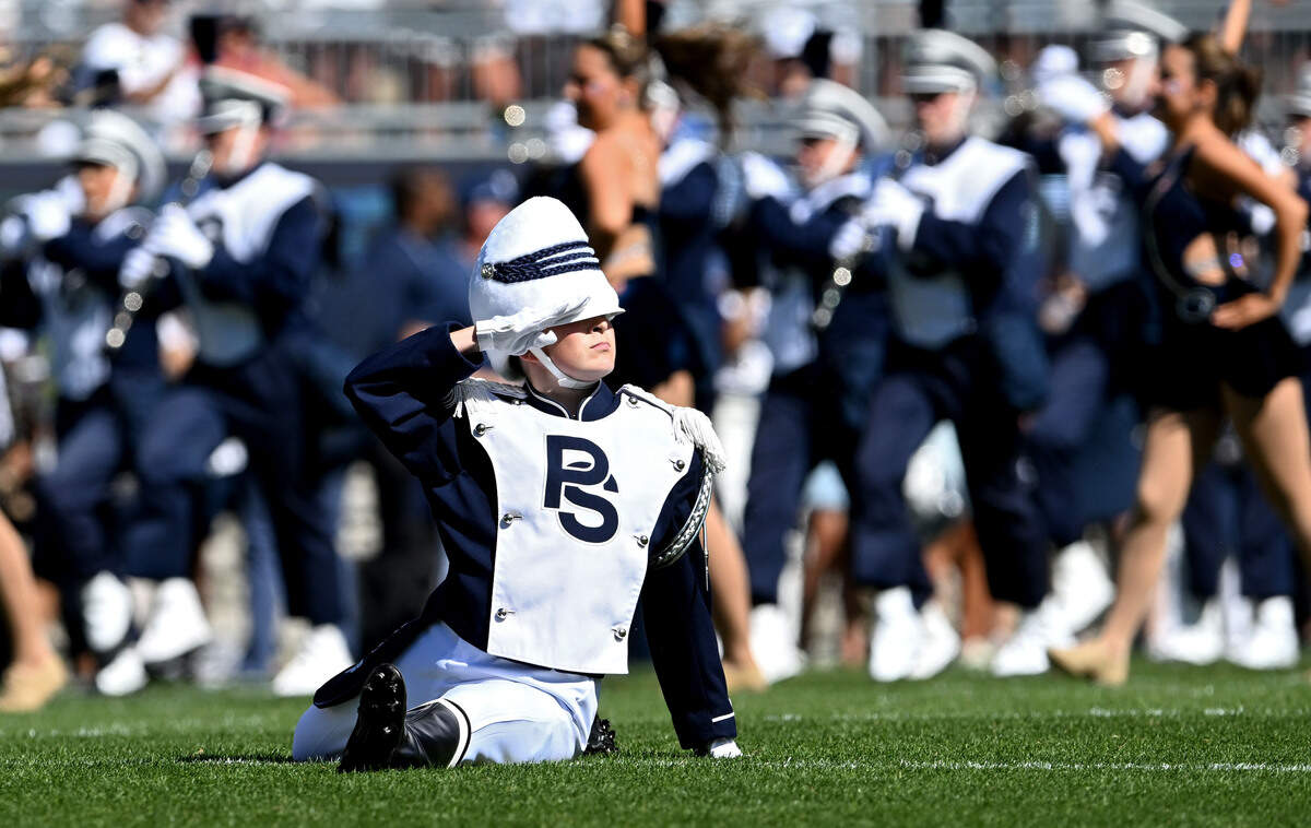 Penn State Blue Band drum major Ellie Sheehan salutes after the first flip of the pregame show on Saturday, Aug. 30, 2025.  