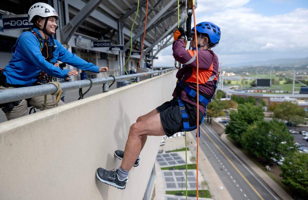 Dean Faye Chadwell, chair of the 2024 Penn State United Way campaign, goes Over the Edge at Beaver Stadium to support the Centre County United Way on Monday.