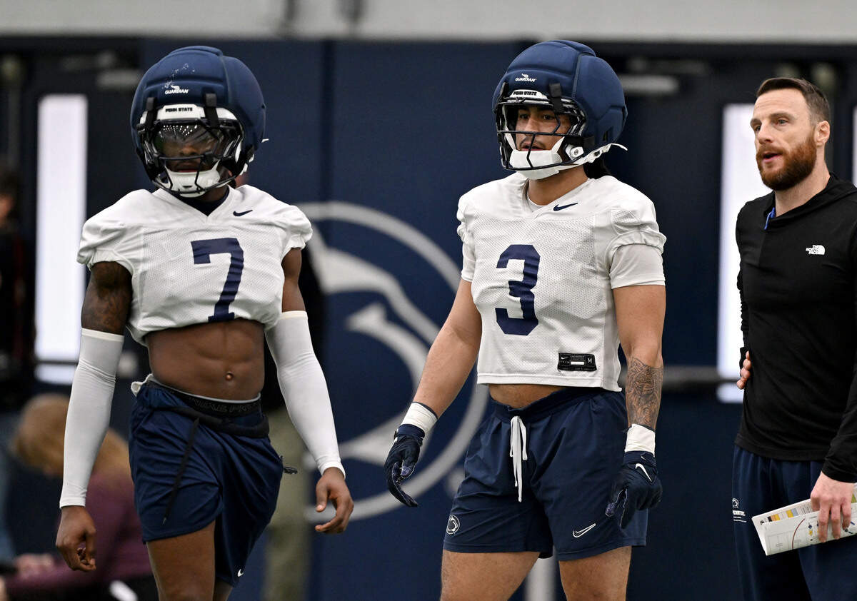 Penn State cornerback Zion Tracy and safety Jamison Patton listen to instructions during spring practice on Thursday, March 26, 2026.