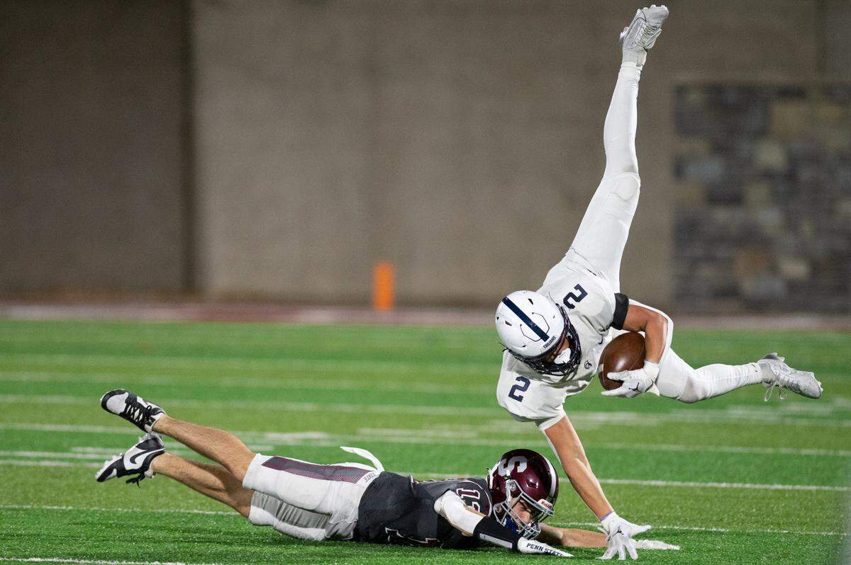 McDowell wide receiver Gavin Magorien jumps into the air as State High defensive back Hank Lustig dives for a tackle during the football game at Memorial Field on Friday, Nov. 8, 2024.