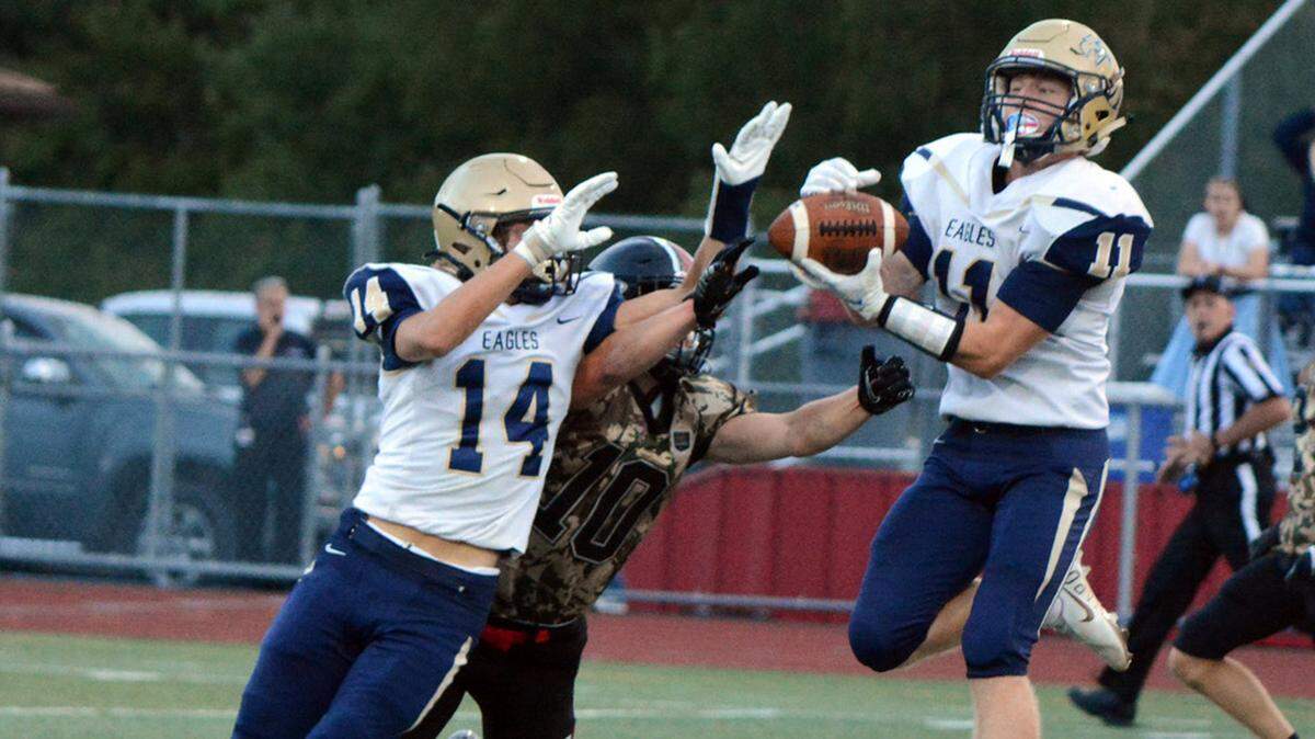 Bald Eagle Area’s Hayden Vaughn picks off a pass intended for Clearfield’s Nate Natoli (10) as teammate Owen Irvin attempts to break the pass up.