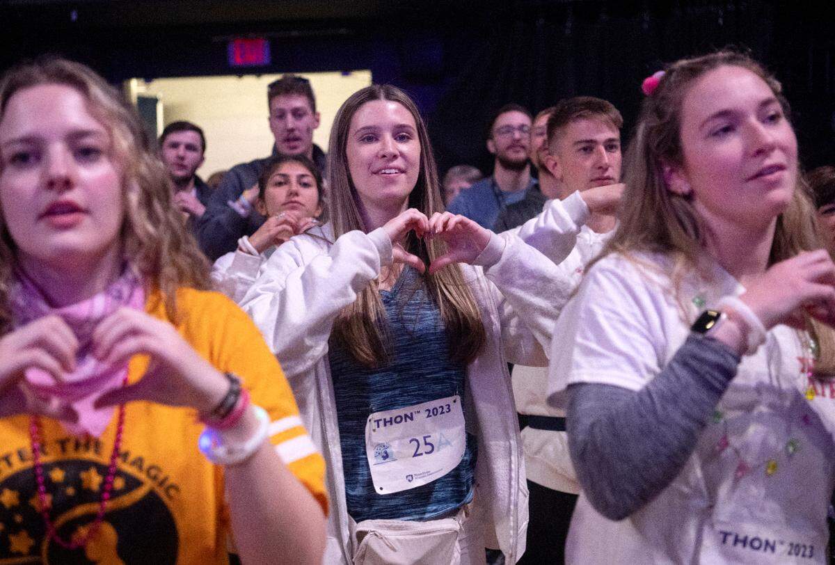 Dancer from Tri Sig Skylar McCullough makes a heart as she does the line dance during the Penn State IFC/Panhellenic Dance Marathon on Saturday Feb. 18, 2023 at the Bryce Jordan Center.