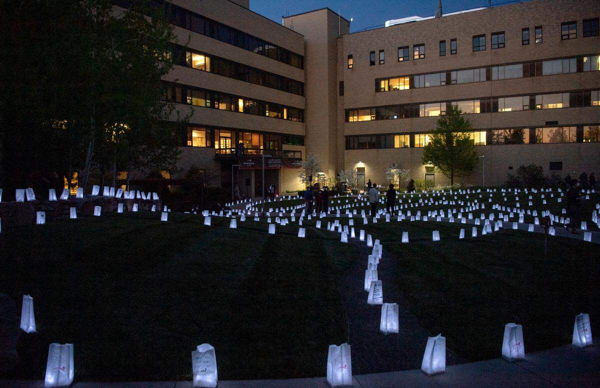 People walk among the luminaries at the Mount Nittany Health Medical Center Healing Garden during the “Luminary Reflection: An evening of Recognition, Remembrance, Gratitude and Hope,” on Monday.