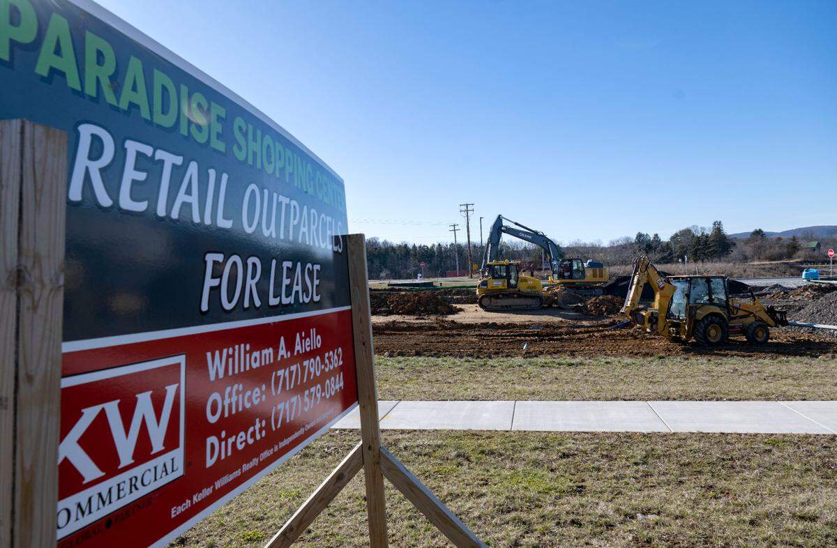 A Construction crew works along Benner Pike at the Paradise Shopping Center on Banner Pike on Tuesday, Feb. 6, 2024.