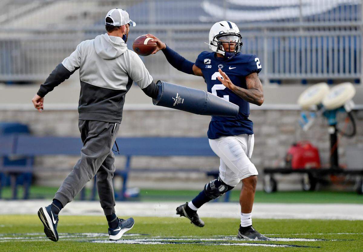 Penn State offensive coordinator Mike Yurcich pressures backup quarterback Ta’Quan Roberson to make a pass during practice on Friday, April 23, 2021 at Beaver Stadium.