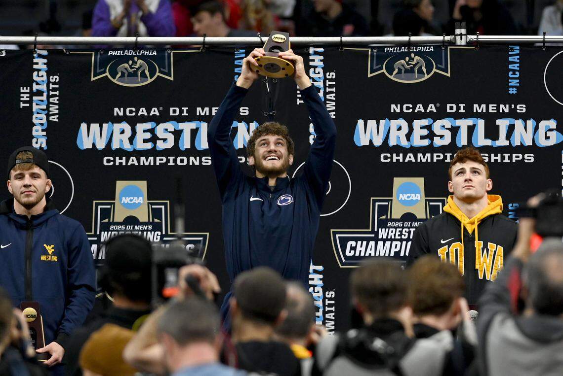 Penn State’s Mitchell Mesenbrink hold up his 165-pound championship trophy at the 2025 NCAA Wrestling Championships at the Wells Fargo Center in Philadelphia on Saturday, March 22, 2025.  