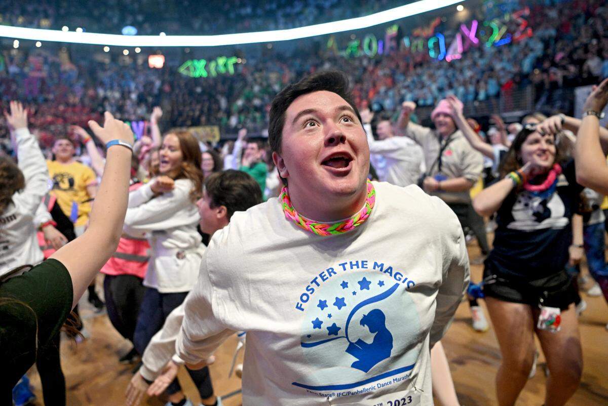 Blake Ray looks to members of his organization Atlas in the stands as they learn the line dance in the first hour of the Penn State IFC/Panhellenic Dance Marathon on Friday, Feb. 17, 2023 at the Bryce Jordan Center.