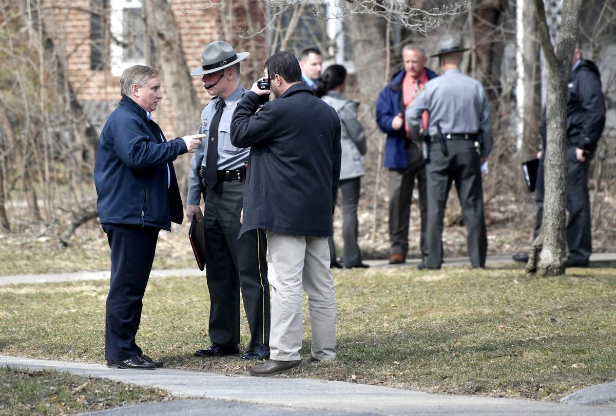 State College police Chief John Gardner talks to a Pennsylvania state trooper and Lt. Greg Brauser during an investigation into a police shooting at the Marvin Gardens apartment complex on March 20, 2019.