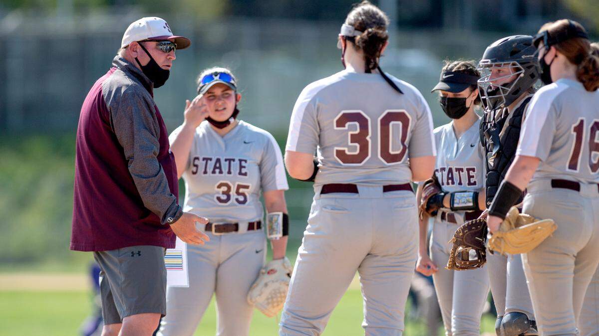 State College’s softball coach Shawn Herncane talk to his team during an April 2021 game. The Lady Little Lions lost a close game to Cumberland Valley on Thursday.