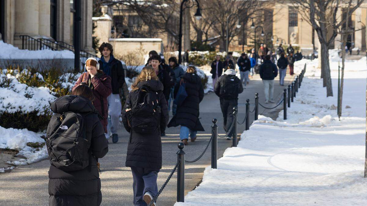 Penn State students are seen walking through campus in between classes on Wednesday at University Park.