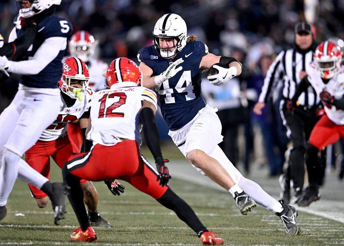 Penn State tight end Tyler Warren cuts down the field with the ball from Maryland defenders during the game on Saturday, Nov. 30, 2024.