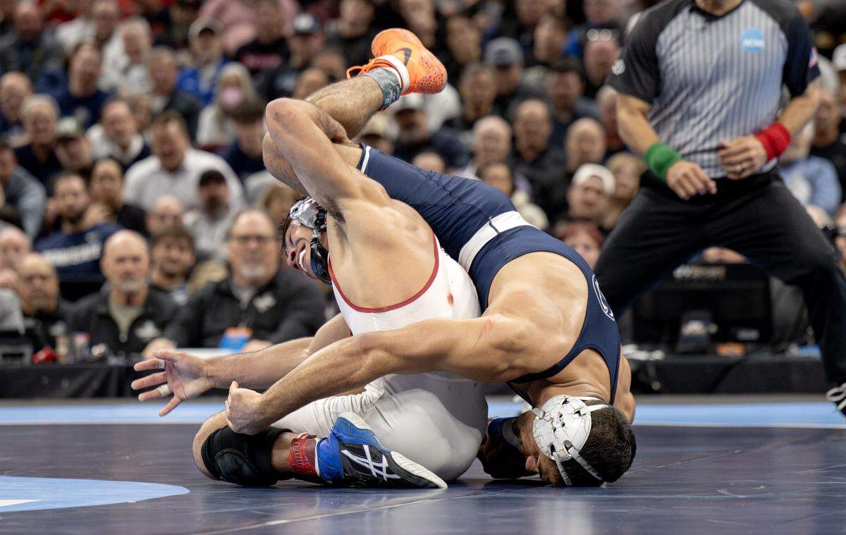 Stanford's Aden Valencia is twisted with Penn State's Shayne Van Ness in sudden victory of the 149-pound championship bout at the NCAA wrestling championships on Saturday, March 21, 2026.