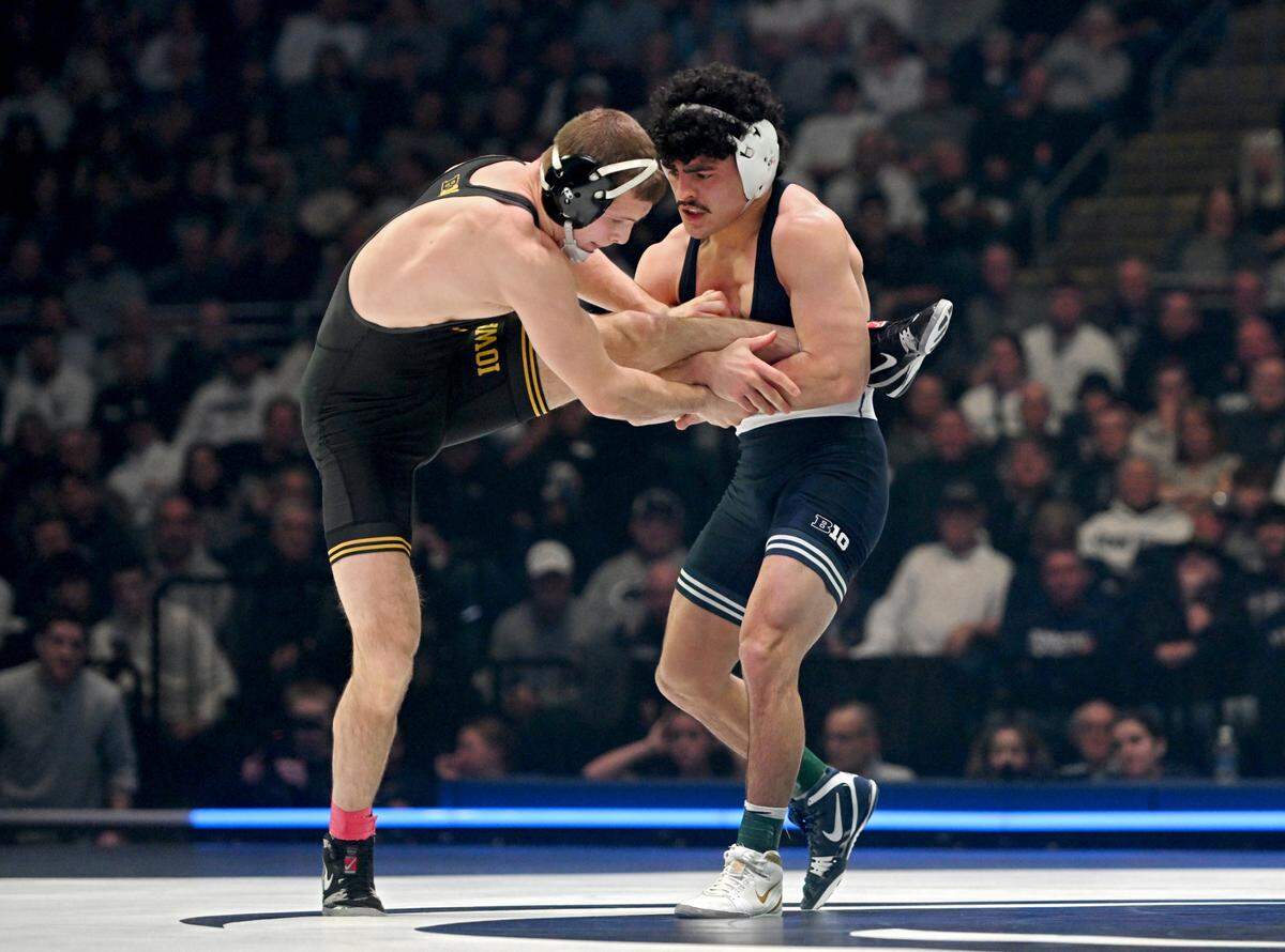 Penn State’s Beau Bartlett trips up Iowa’s Cullan Schriever in the 141-pound bout of the match on Friday, Jan. 31, 2025 at the Bryce Jordan Center. Bartlett won by decision, 7-3.