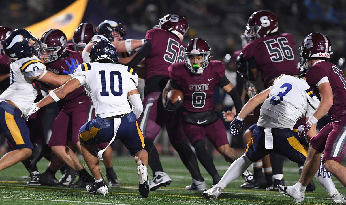State College’s Connor Kulka (10) looks for an opening in Central Catholic’ defense in first half action of the PIAA Class 6A quarterfinal action Friday, Nov. 21, 2025, at Altoona’s Mansion Park.