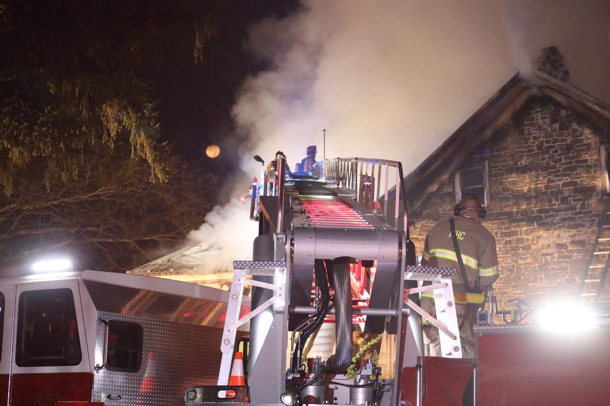 Crews work to extinguish a fire at the Woodward Inn in Haines Township early Sunday morning.
