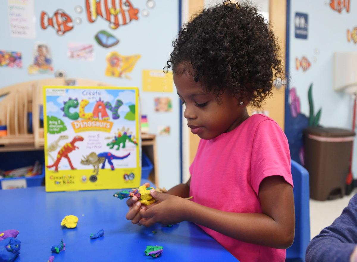 Carsyn King, 5, plays with a dinosaur for the Preschooler-Approved Toy Test Friday, Sept. 28, 2018 at The Goddard School in State College.